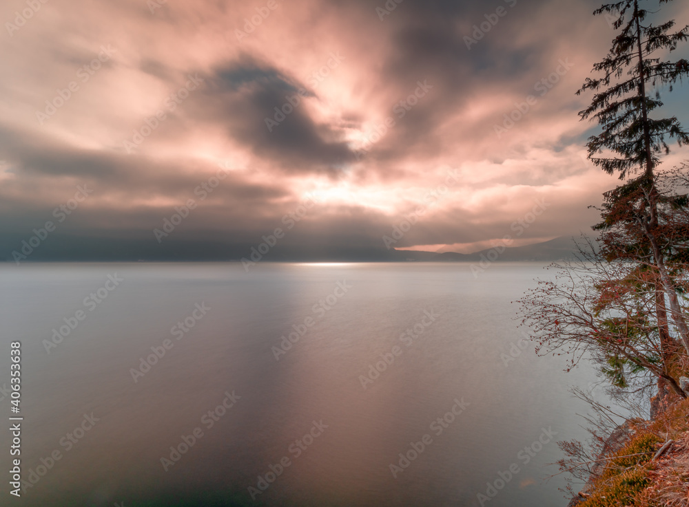 Walchensee as one of beautiest Bavarian lakes during sunset phase with warm red cloud scenery