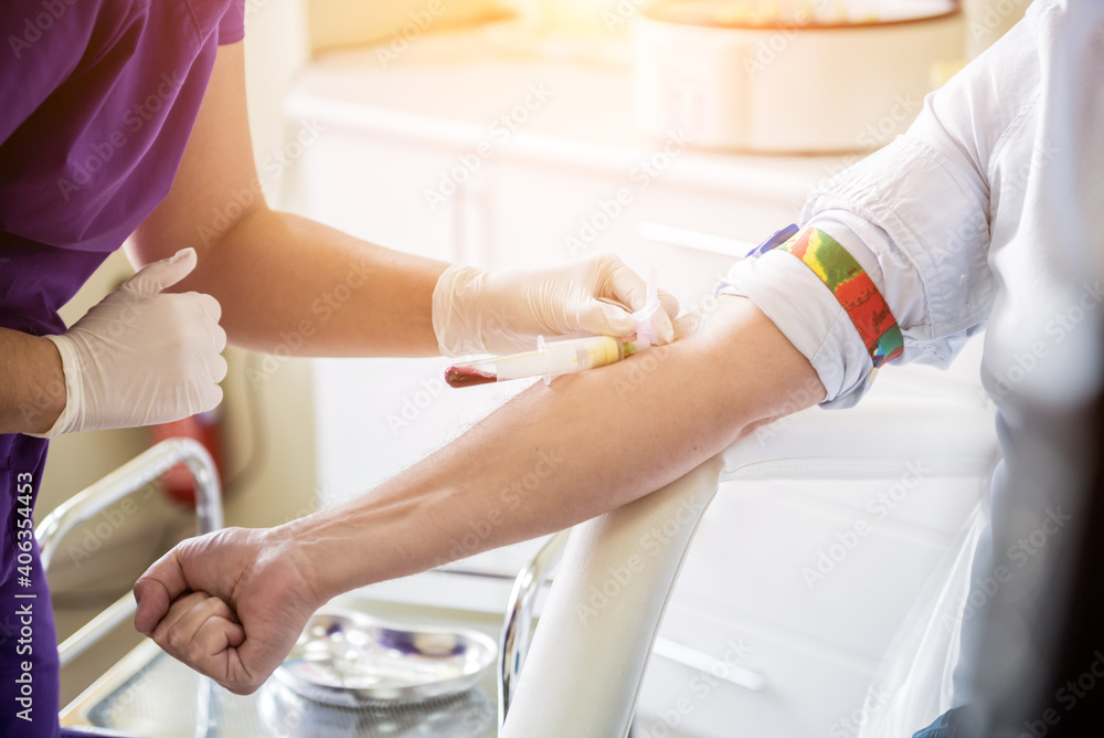 Nurse taking a patient's blood sample at lab Nurse taking a patient's blood sample at lab