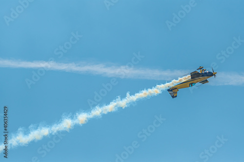 The aerobatic plane with smoke track in the sky photo