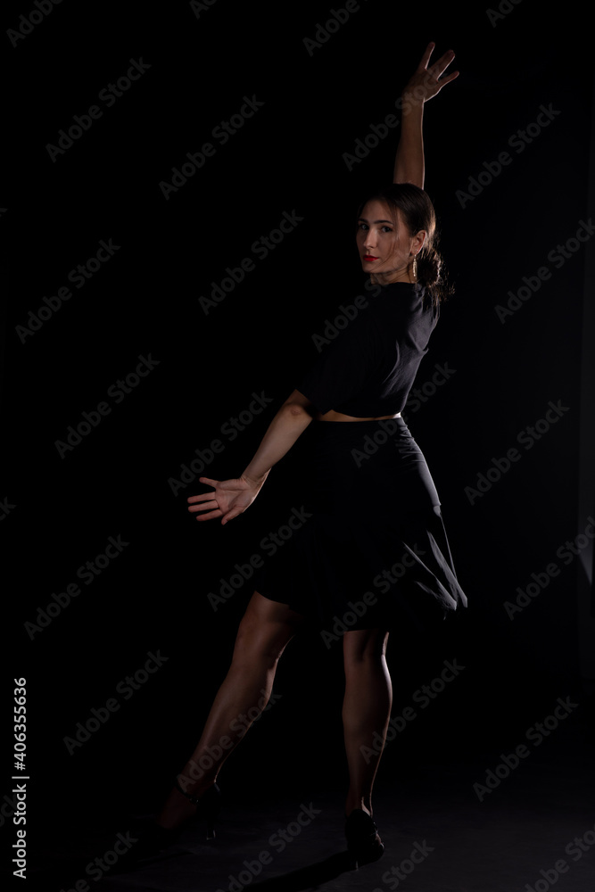 Young Woman in a black dress dancing, Young professional dancer practicing in a studio , dancer