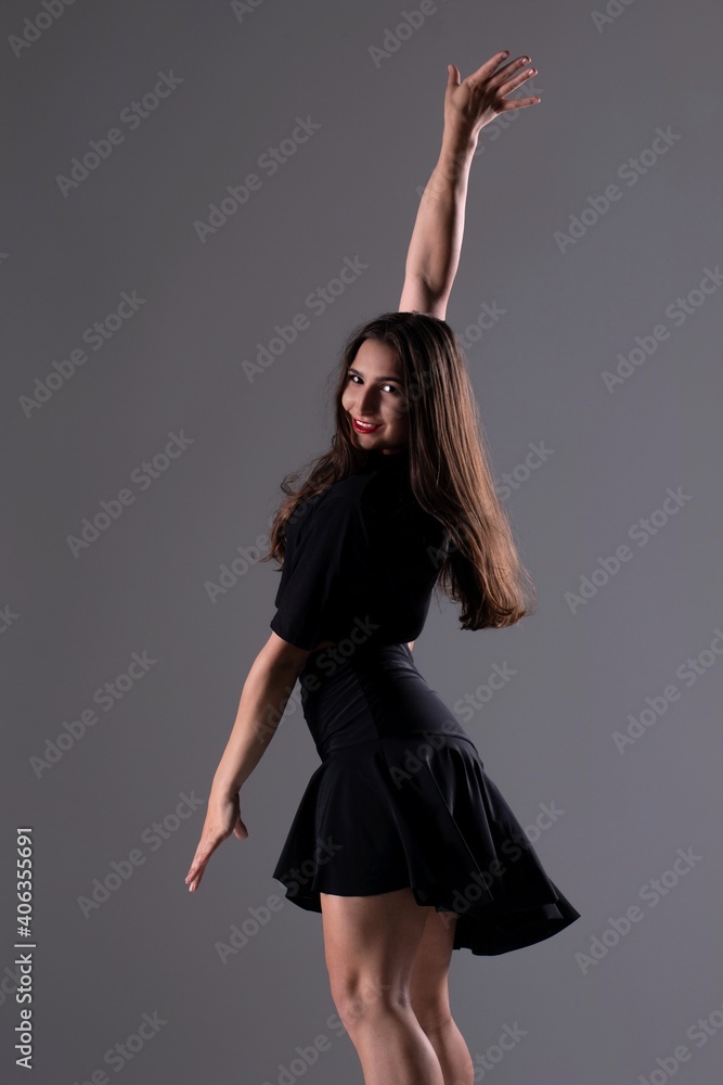 Young Woman in a black dress dancing, Young professional dancer practicing in a studio , dancer Young Woman in a black dress dancing, Young professional dancer practicing in a studio , dancer
