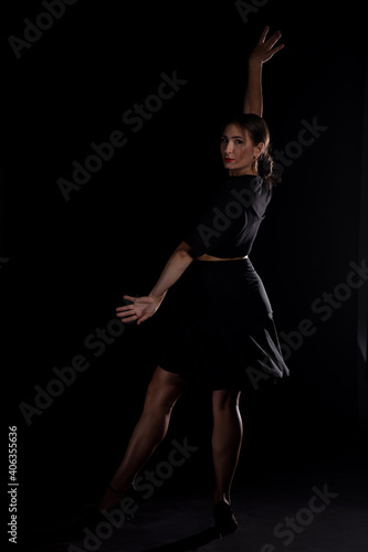 Young Woman in a black dress dancing, Young professional dancer practicing in a studio , dancer