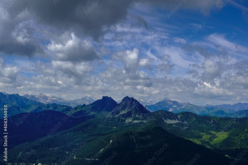 two peaks in a mountain landscape with dark clouds on the sky