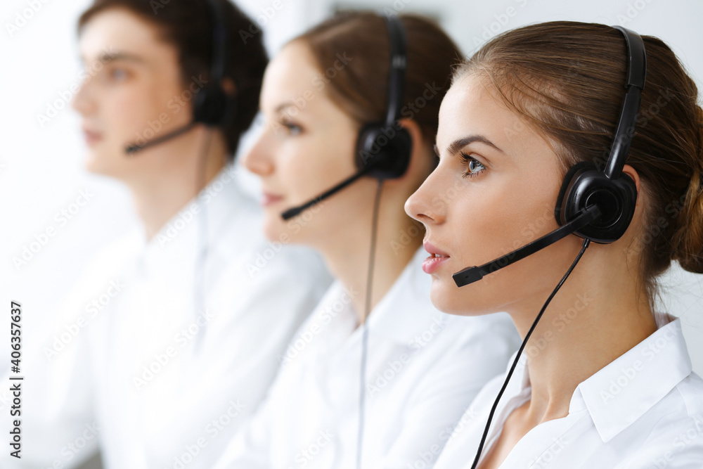 Call center. Beautiful young woman using headset and computer to help customers. Business concept Call center. Beautiful young woman using headset and computer to help customers. Business concept