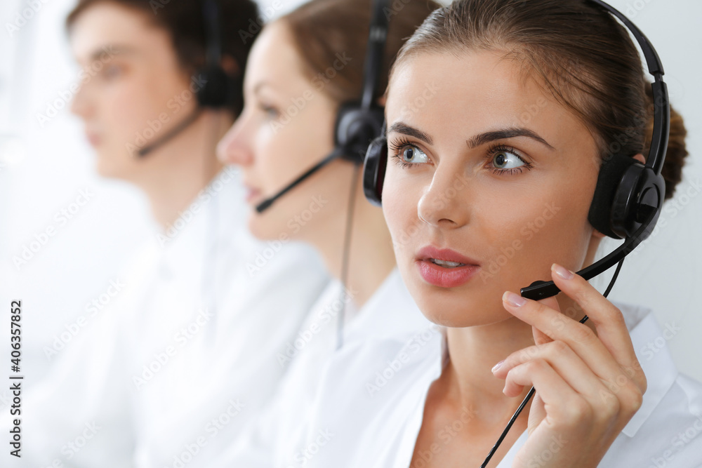 Call center. Beautiful young woman using headset and computer to help customers. Business concept Call center. Beautiful young woman using headset and computer to help customers. Business concept