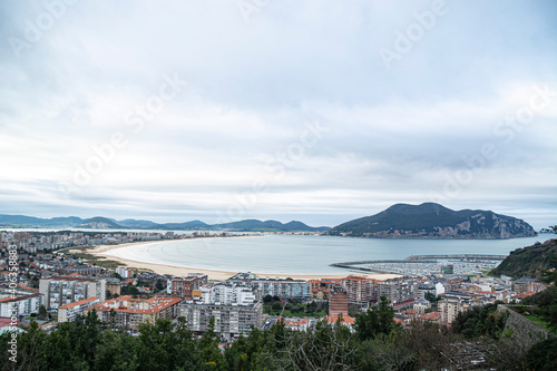 Aerial view of Laredo beach with the island of Santoña in the background in a sunset