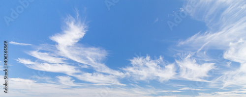 Blue sky panoramic background with beautiful wispy clouds.