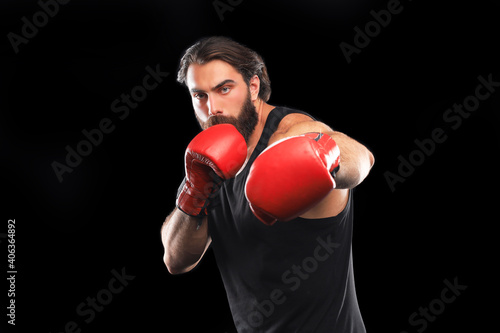 Kickboxer man fighting against black background. Sport concept.
