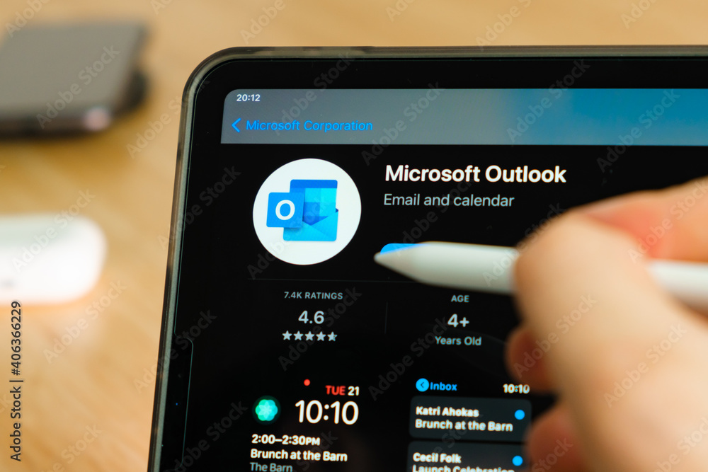 Microsoft Outlook logo shown by apple pencil on the iPad Pro tablet screen.  Man using application on the tablet. December 2020, San Francisco, USA.  Photos | Adobe Stock