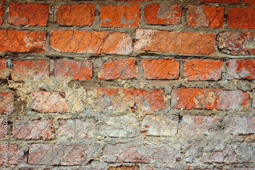 Textured brick wall behind a wire mesh-fragment