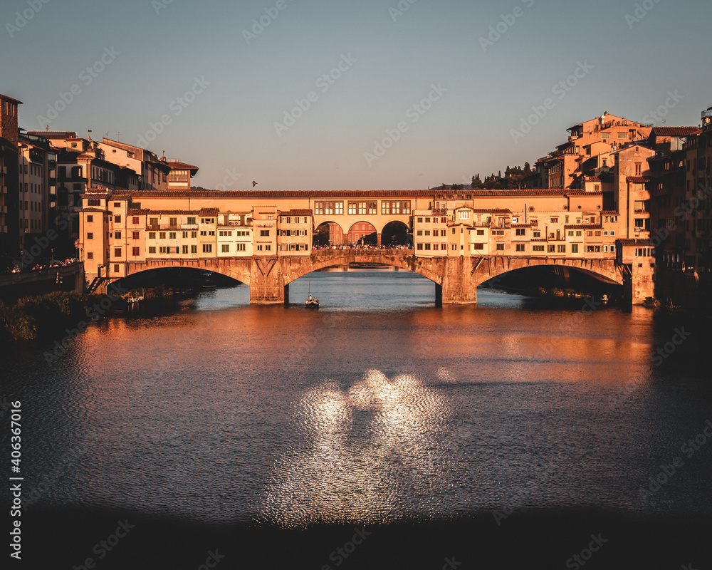 view of the famous Ponte Vecchio bridge over the Arno river before sunset. view of the famous Ponte Vecchio bridge over the Arno river before sunset.