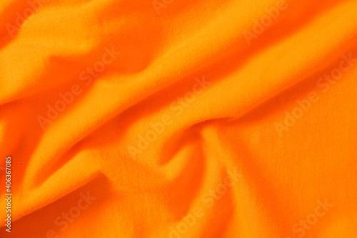 Texture of orange fabric as background, top view