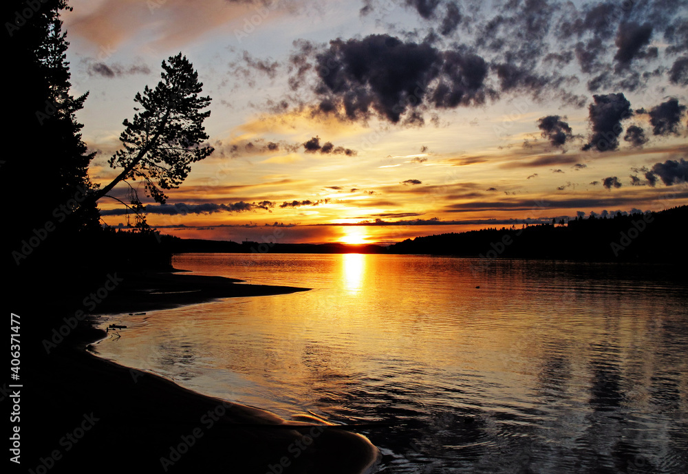 Naklejka premium sunset in the summer by the river in Lycksele