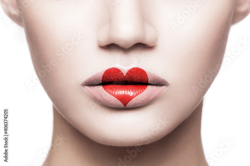 Closeup portrait of beautiful woman face with makeup and red heart shape on her lips. valentines day and beauty love and care concept. indoor studio shot  Isolated on white background.