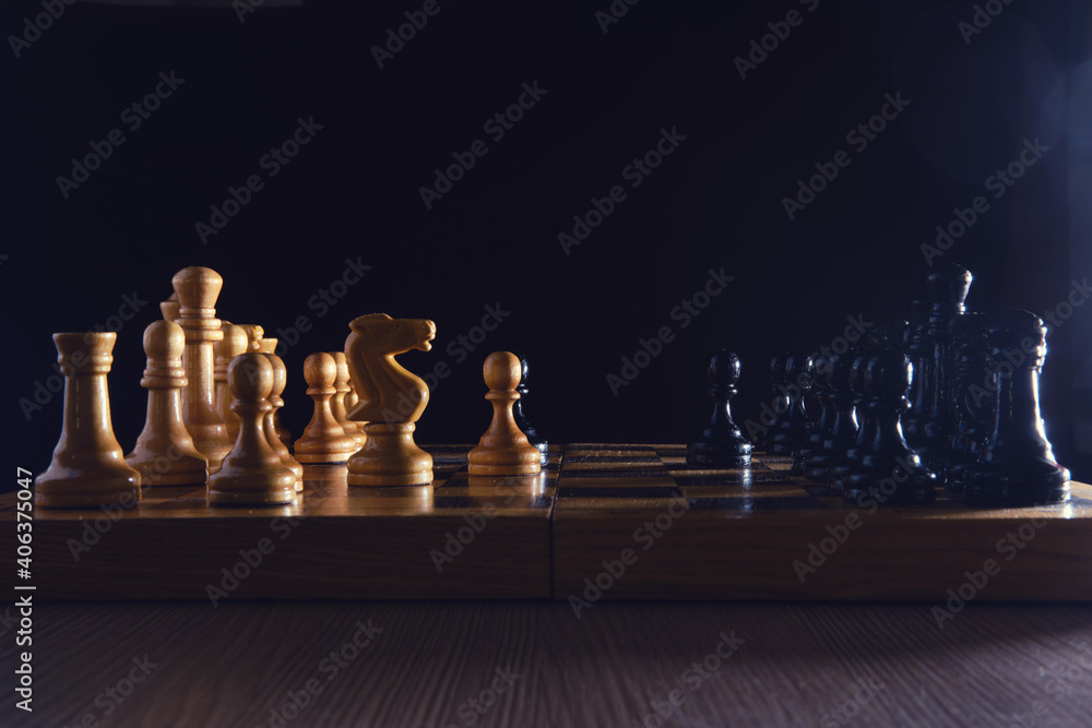 Old chess board with figures from the Soviet Union era on a black background. Chess debut Sicilian defense Old chess board with figures from the Soviet Union era on a black background. Chess debut Sicilian defense