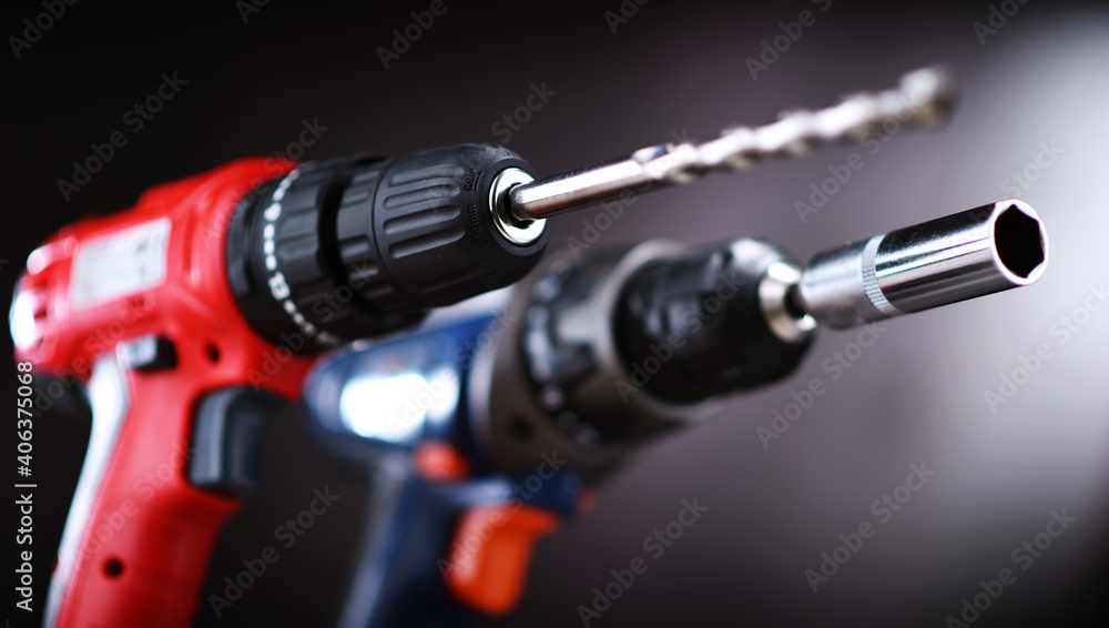 A pistol-grip cordless drill and a screw gun A pistol-grip cordless drill and a screw gun