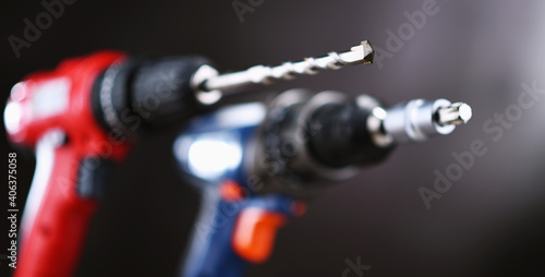 A pistol-grip cordless drill and a screw gun