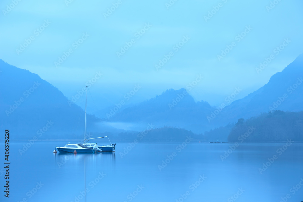 Stunning landscape image of misty Derwentwater in Lake District on cold Winter morning Stunning landscape image of misty Derwentwater in Lake District on cold Winter morning