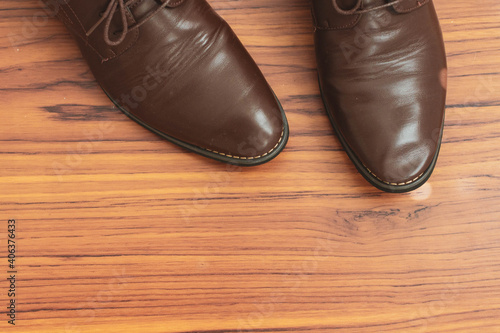 leather shoe with wooden background