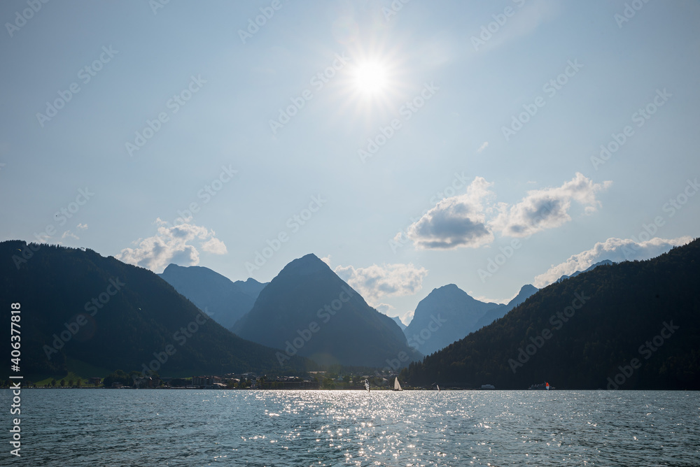 lake Achensee, view to tourist area Pertisau, blue sky with bright sun