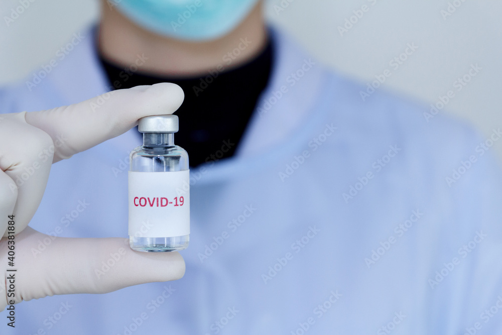 Doctor's hand holding bottle vaccine Covid-19, Medication treatment concept. Doctor's hand holding bottle vaccine Covid-19, Medication treatment concept.