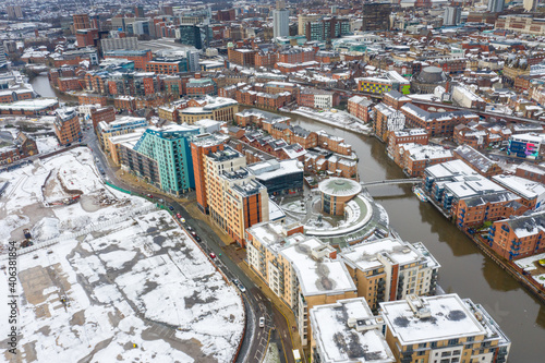 Aerial photo of the area in the Leeds City Centre known as Brewery Wharf showing snow covered apartment buildings along side the Leeds and Liverpool canal in the winter time photo