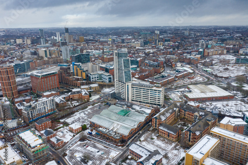 Aerial photo of the town centre of Leeds in West Yorkshire  near the Bridgewater Place apartment building along side the Leeds Train Station in the snow and winter time