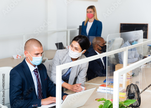 caucasian and asian businessperson with mask in white room photo