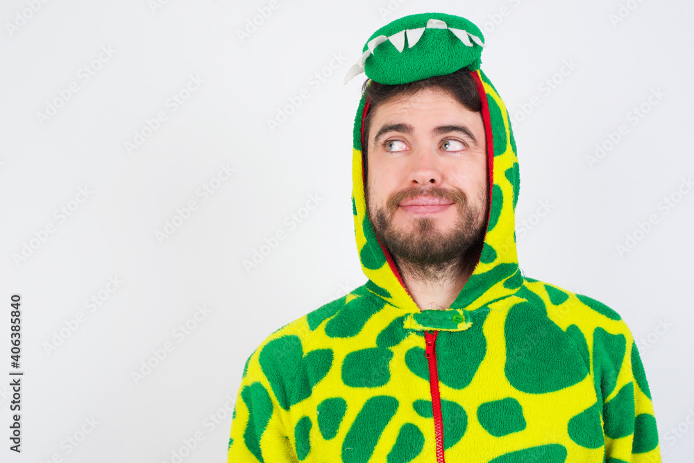 Fototapeta premium Young caucasian man wearing a pajama standing against white background looking aside into empty space thoughtful