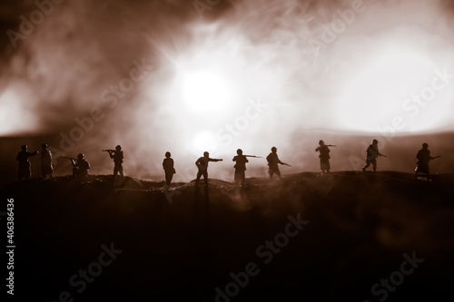 War Concept. Military silhouettes fighting scene on war fog sky background, World War Soldiers Silhouette Below Cloudy Skyline At night. Battle in ruined city. © zef art