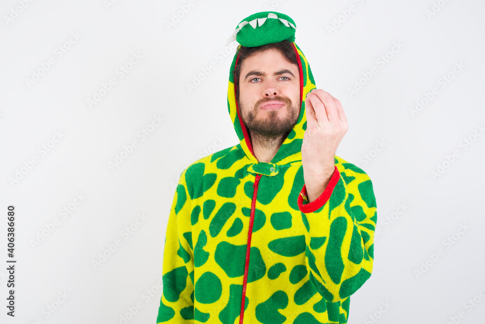 Young caucasian man wearing a pajama standing against white background angry gesturing typical italian gesture with hand, looking to camera Young caucasian man wearing a pajama standing against white background angry gesturing typical italian gesture with hand, looking to camera