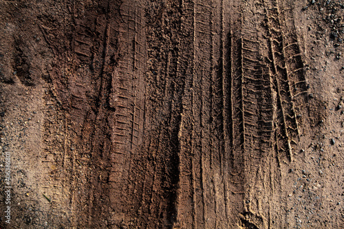 Tyre track on dirt sand or mud, Picture in retro or grunge tone. Car drive on sand. off road track. Track on grass field. Track in farm.