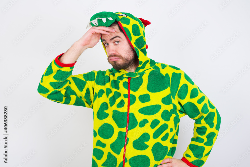 Fototapeta premium Young caucasian man wearing a pajama standing against white background having problems, worried and stressed holds hand on forehead.