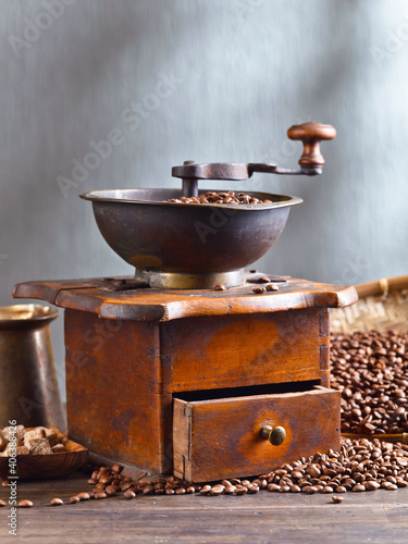 Old coffee grinder and roasted coffee beans