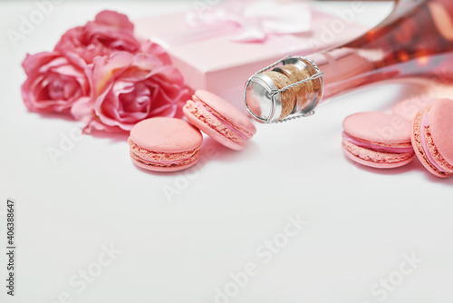 Macaroon sweets and bottle of champagne. Romantic breakfast and dinner.. Valentine's day greeting card. Flowers and gifts boxes on white background. Happy birthday and mother's day template.
