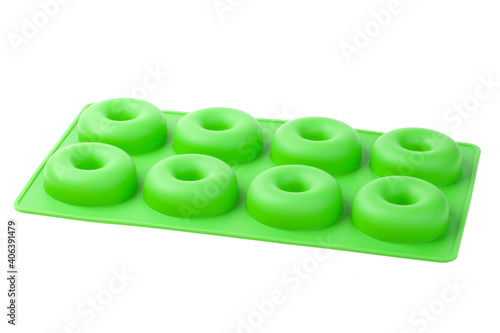 Green silicone shape donut isolated on white background. Bakeware.