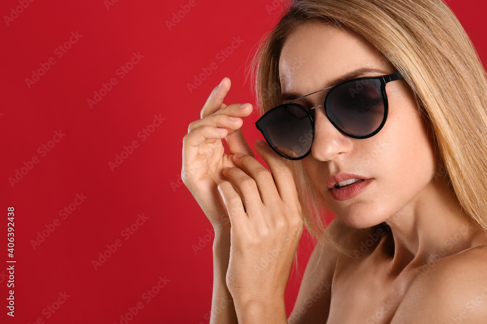 Beautiful woman in stylish sunglasses on red background. Space for text Beautiful woman in stylish sunglasses on red background. Space for text