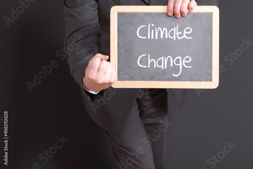 Manager with a chalkboard and the keyword Climate Change
