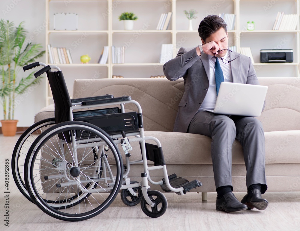 Dsabled businessman on wheelchair working home Dsabled businessman on wheelchair working home