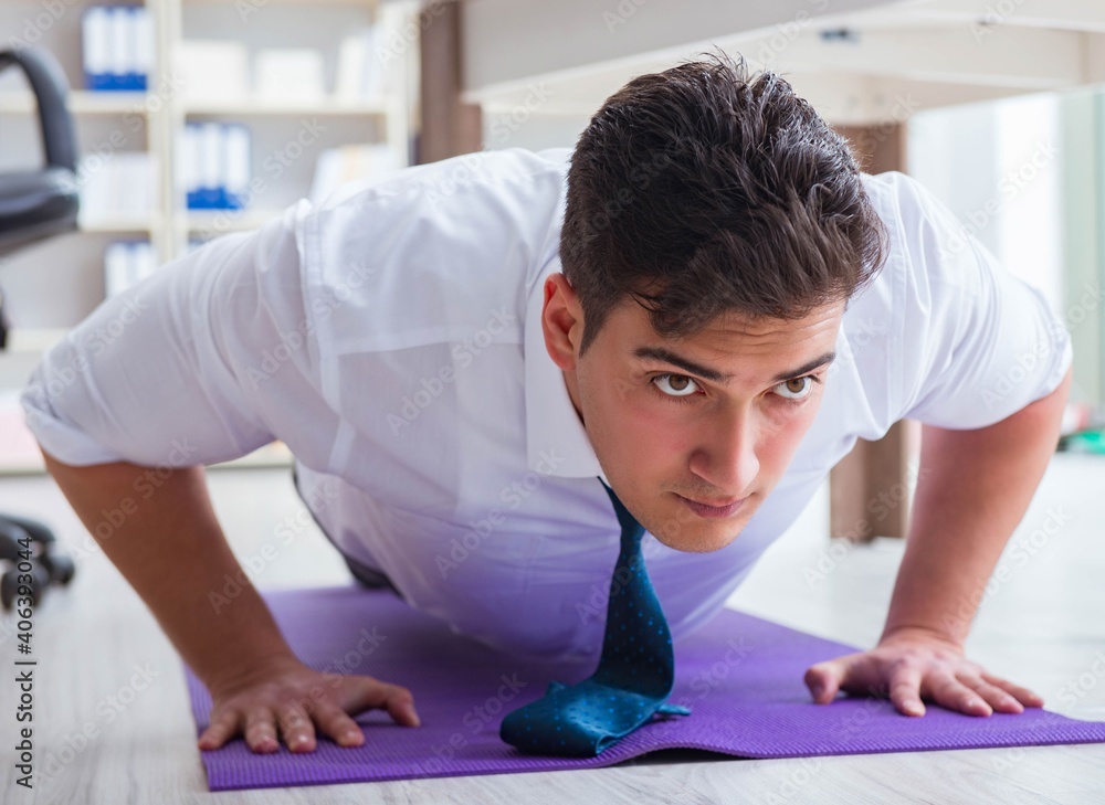 Businessman doing sports at his office space Businessman doing sports at his office space