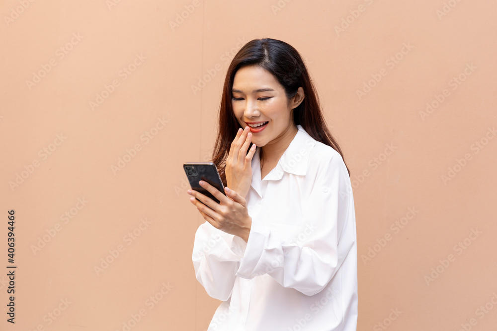 Asian woman reads content from a smartphone and video call Asian woman reads content from a smartphone and video call