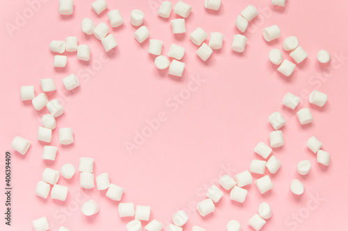 Marshmallow heart frame on a pink background. Concept of love, happy valentine's day, women's day and birthday celebration. Flatly, copy space, mock up, banner.