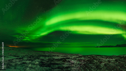 Northern Lights over the mountains, the Barents Sea and the Arctic Ocean. Russia, Murmansk region, Teriberka.