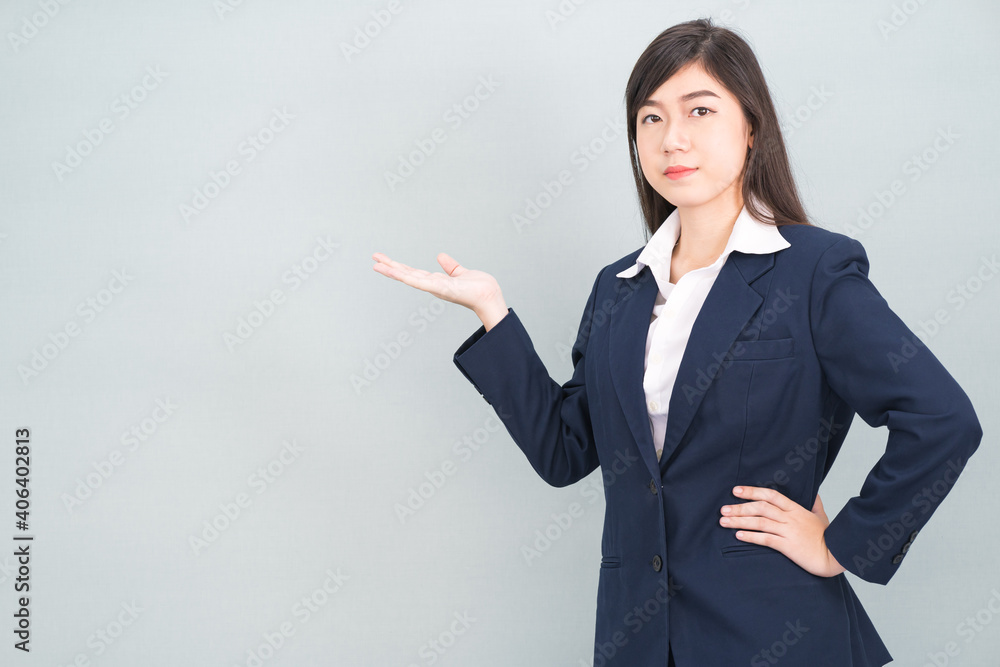 Asian woman in suit open hand palm gestures with empty space Asian woman in suit open hand palm gestures with empty space