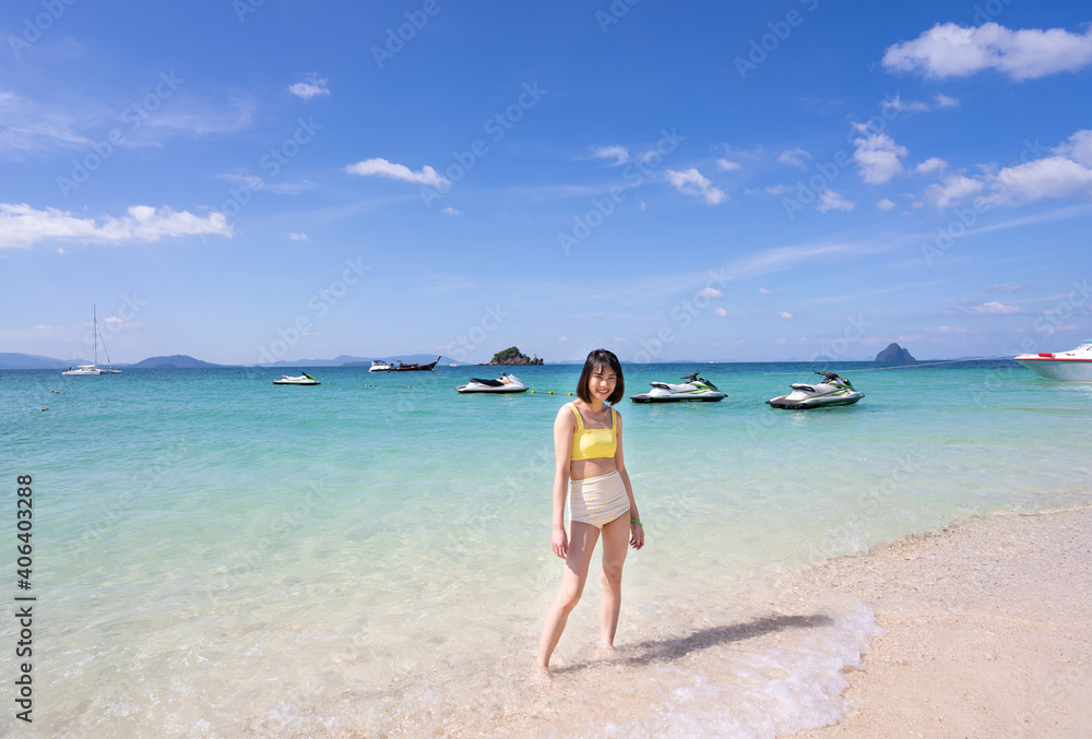 Close up summer portrait of young Asian woman in yellow bikini on tropical beach. Holliday summer concept Close up summer portrait of young Asian woman in yellow bikini on tropical beach. Holliday summer concept