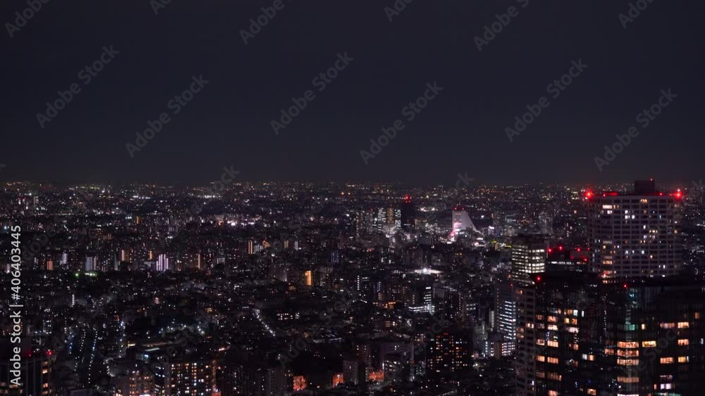 High above aerial night cityscape of Tokyo suburban area with flickering lights High above aerial night cityscape of Tokyo suburban area with flickering lights
