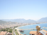 View beach of the Alanya coast from mountain. Boats floats in mediterian sea.