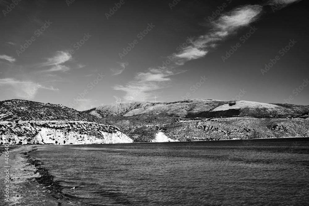 rocky coast and windmills on a hill on the island of Kefalonia
