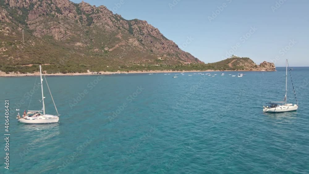 Drone Fly Over White Boats at Crystal Tropical Sea. Mountains on Background. Sardinia, Italy Drone Fly Over White Boats at Crystal Tropical Sea. Mountains on Background. Sardinia, Italy