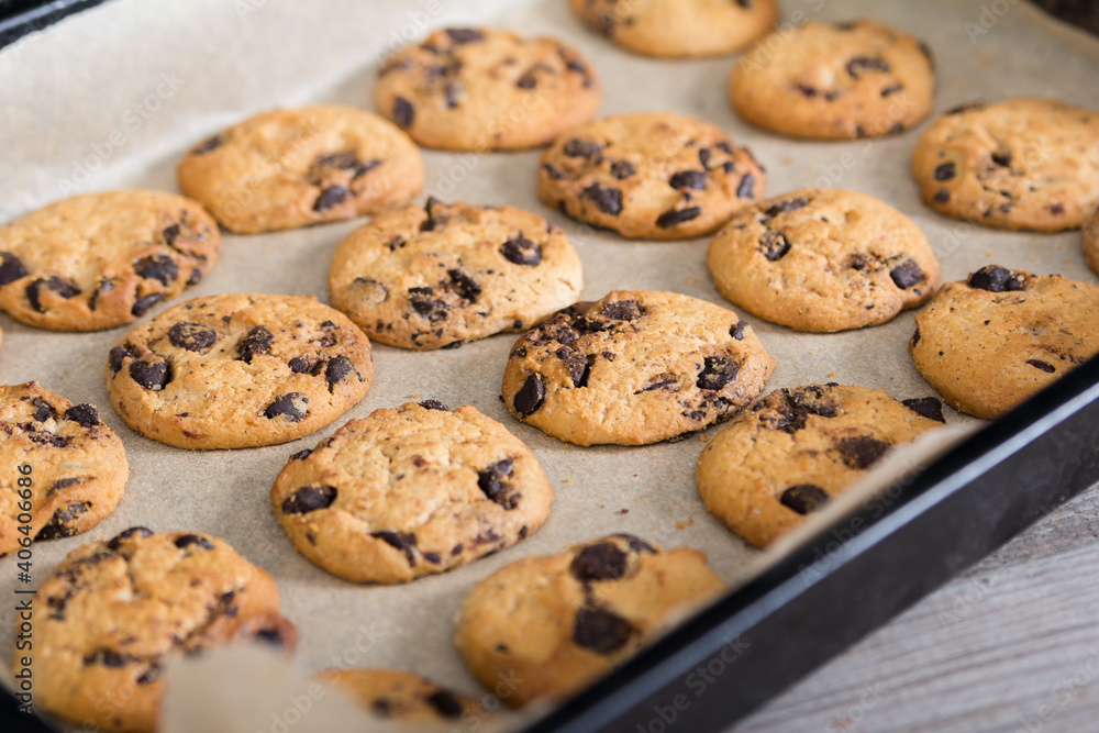 Freshly baked cookies with chocolade chips on baking tray
